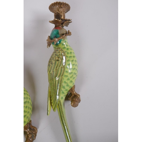 197 - A pair of polychrome porcelain parrot candle sconces with gilt metal mounts, 48cm