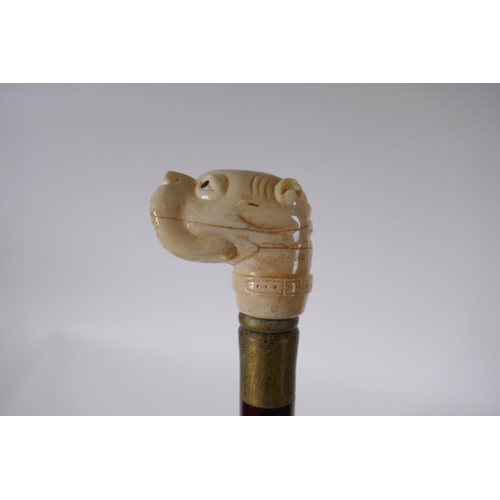 199 - A bone handled walking stick carved in the form of a dog's head, 90cm long