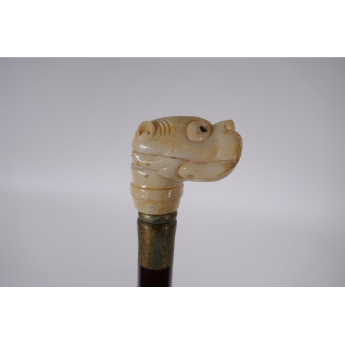 199 - A bone handled walking stick carved in the form of a dog's head, 90cm long