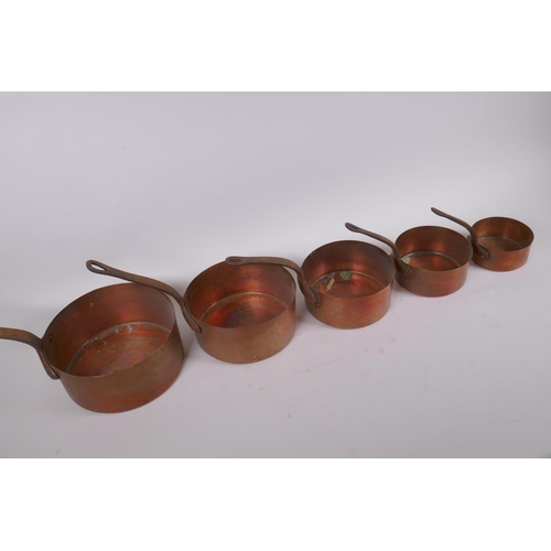 200 - A set of five graduated copper sauce pans, largest 15cm diameter