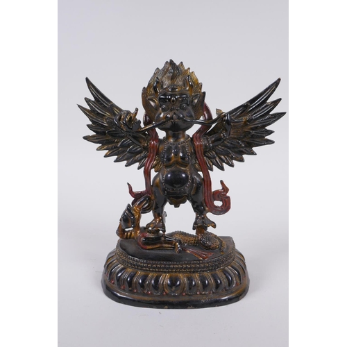 201 - A Tibetan bronze figure of Garuda with painted and gilt details, 18cm high