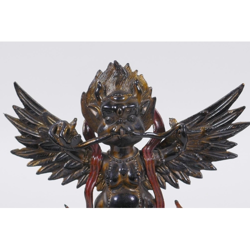 201 - A Tibetan bronze figure of Garuda with painted and gilt details, 18cm high