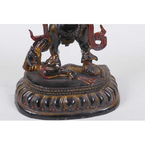 201 - A Tibetan bronze figure of Garuda with painted and gilt details, 18cm high