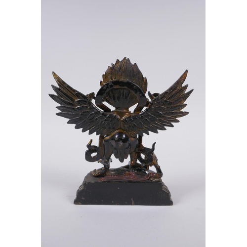 201 - A Tibetan bronze figure of Garuda with painted and gilt details, 18cm high