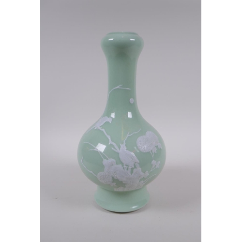 203 - A celadon glazed porcelain garlic head shaped vase with raised white enamel decoration of birds and ... 