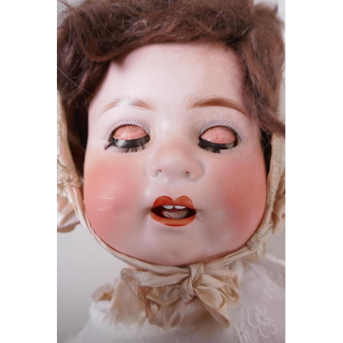 21 - An antique German Heubach Koppelsdorf bisque headed toddler doll with brown sleeping eyes, moving cl... 