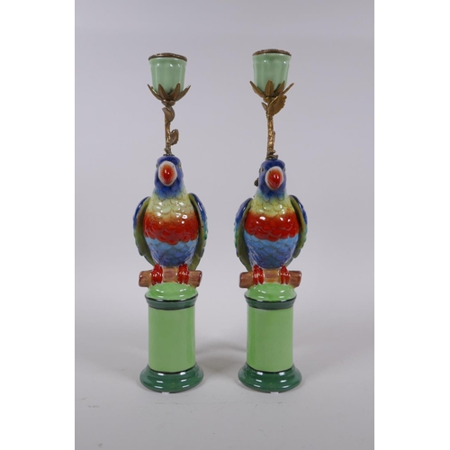 210 - A pair of polychrome porcelain and gilt metal parrot candlesticks, 32cm high