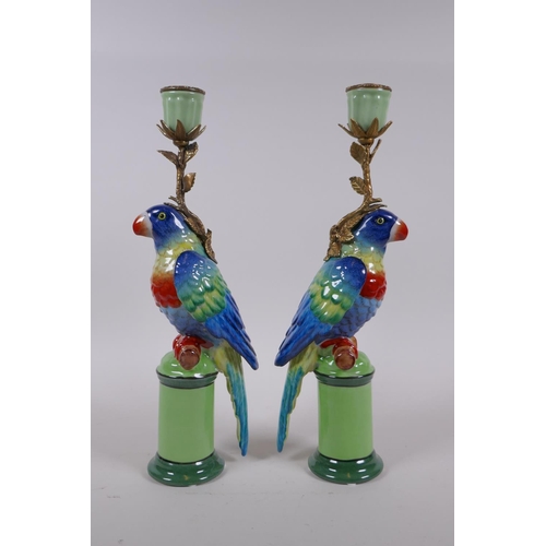 210 - A pair of polychrome porcelain and gilt metal parrot candlesticks, 32cm high