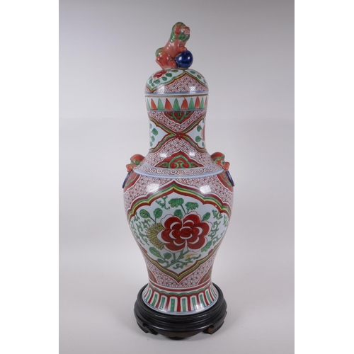 211 - A Chinese porcelain jar and cover with two kylin mask handles, Fo dog knop and red and green floral ... 