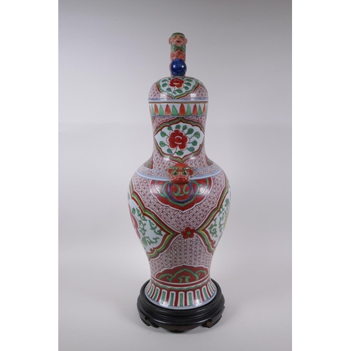 211 - A Chinese porcelain jar and cover with two kylin mask handles, Fo dog knop and red and green floral ... 