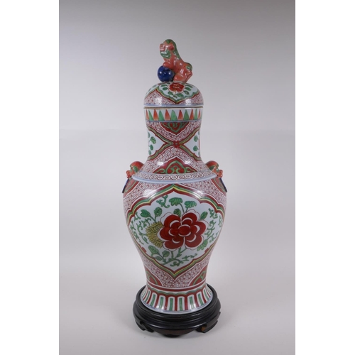 211 - A Chinese porcelain jar and cover with two kylin mask handles, Fo dog knop and red and green floral ... 