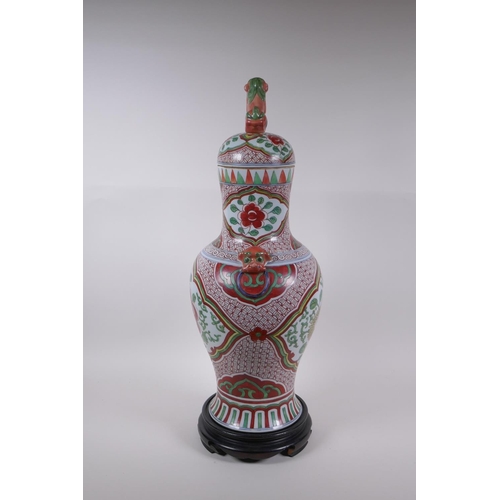 211 - A Chinese porcelain jar and cover with two kylin mask handles, Fo dog knop and red and green floral ... 