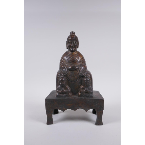 213 - A Chinese gilt bronze figure of Buddha seated on a throne, inscription verso, 26cm high