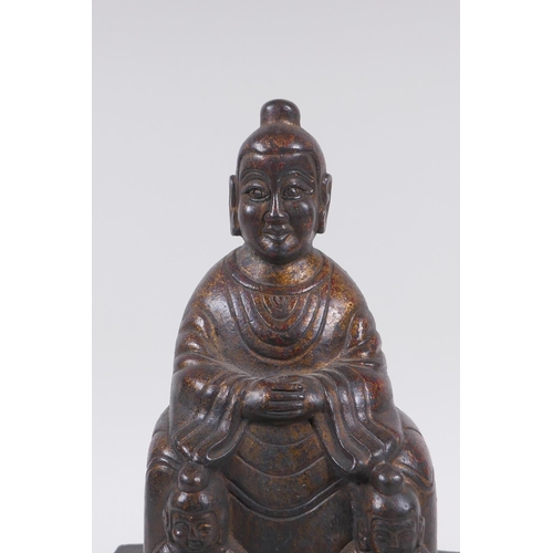 213 - A Chinese gilt bronze figure of Buddha seated on a throne, inscription verso, 26cm high