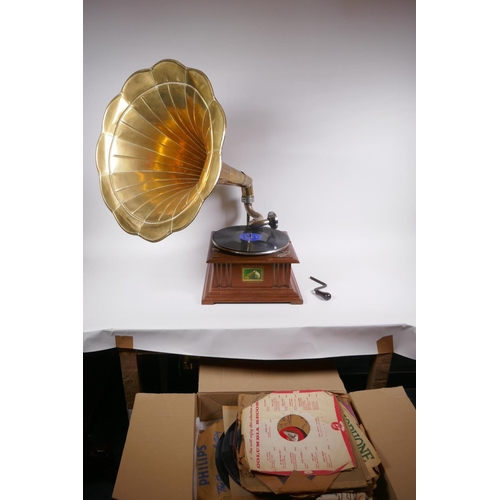 214 - A reproduction HMV gramophone with brass horn, and a collection of 75s, horn 46cm diameter