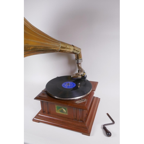 214 - A reproduction HMV gramophone with brass horn, and a collection of 75s, horn 46cm diameter