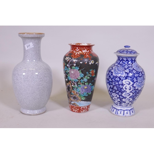 217 - An oriental blue and white jar and cover, 30cm high, a famille noir vase with floral decoration and ... 