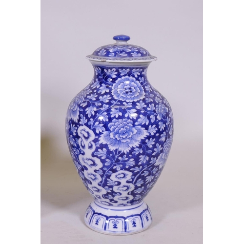 217 - An oriental blue and white jar and cover, 30cm high, a famille noir vase with floral decoration and ... 