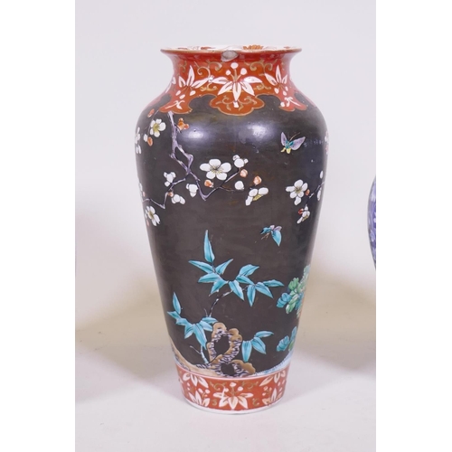 217 - An oriental blue and white jar and cover, 30cm high, a famille noir vase with floral decoration and ... 