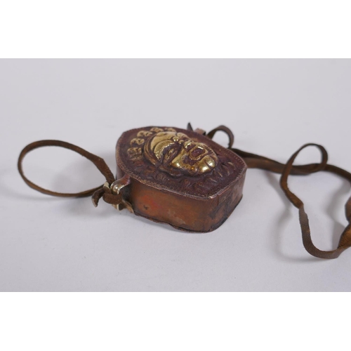 222 - A Tibetan copper gau prayer box, with gilt repousse decoration of a wrathful deity, 6 x 6cm