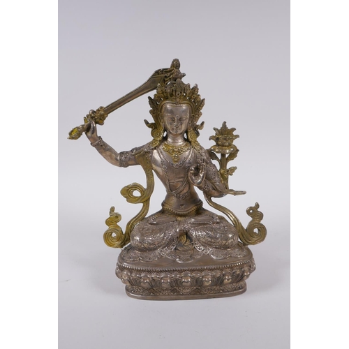 233 - A Tibetan silvered metal figure of Buddha, with gilt highlights, 22cm high