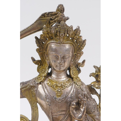 233 - A Tibetan silvered metal figure of Buddha, with gilt highlights, 22cm high