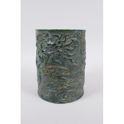 235 - A Chinese carved green hardstone brush pot decorated with a dragon and phoenix, Qianlong seal mark t... 