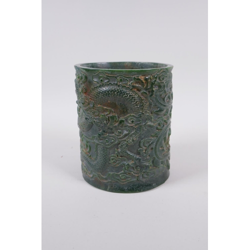 235 - A Chinese carved green hardstone brush pot decorated with a dragon and phoenix, Qianlong seal mark t... 