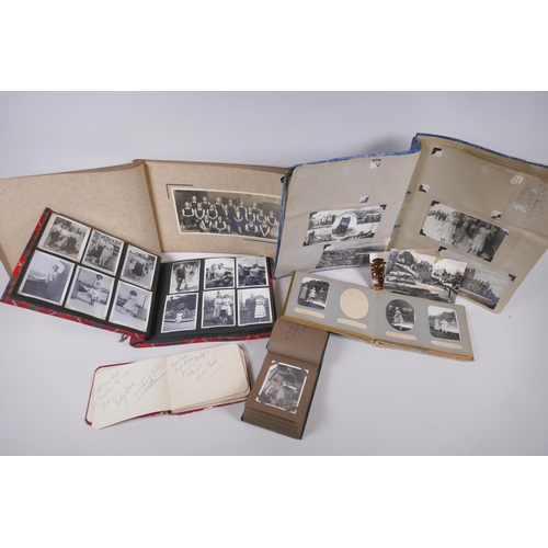 251 - A collection of early C20th photo albums, postcard albums and autograph books, of social historical ... 