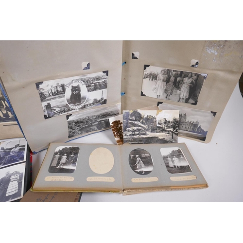 251 - A collection of early C20th photo albums, postcard albums and autograph books, of social historical ... 