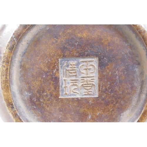 258 - A Chinese bronze censer with Fo dog mask handles, impressed seal mark to base, 12cm diameter