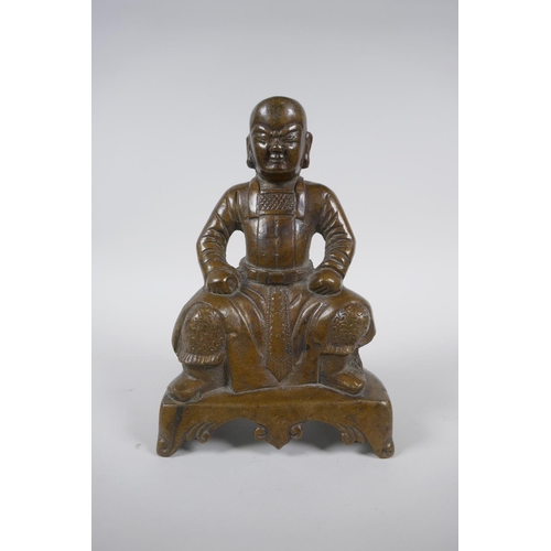 260 - An oriental bronze figure of a seated deity, 21cm high