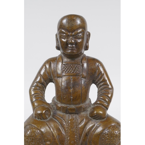 260 - An oriental bronze figure of a seated deity, 21cm high