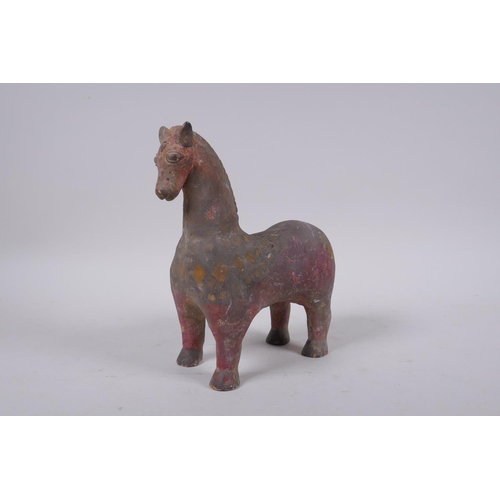 266 - A middle eastern painted terracotta horse, 21cm high