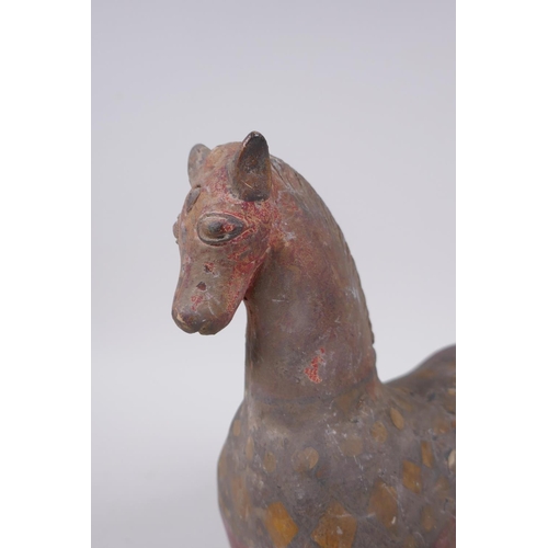 266 - A middle eastern painted terracotta horse, 21cm high