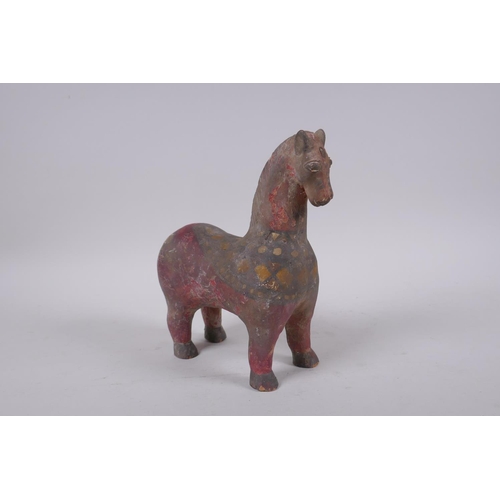 266 - A middle eastern painted terracotta horse, 21cm high