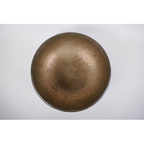 274 - A large Tibetan bronze singing bowl with hammered finish and wood hammer, 13cm high x 28cm diameter