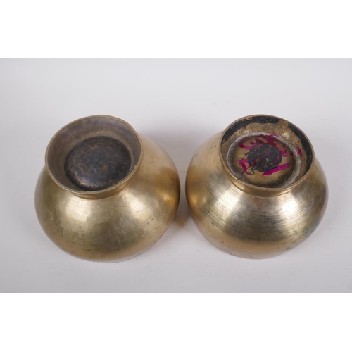 275 - A pair of Tibetan polished bronze footed singing bowls, with wood hammer, 12cm high x 19cm diameter