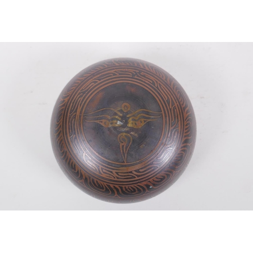 278 - A Tibetan bronze singing bowl with etched decoration and inscriptions, with a wood hammer, 7.5 cm hi... 