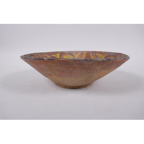 282 - An Islamic terracotta bowl decorated with a unique design, AF repairs, 23cm diameter