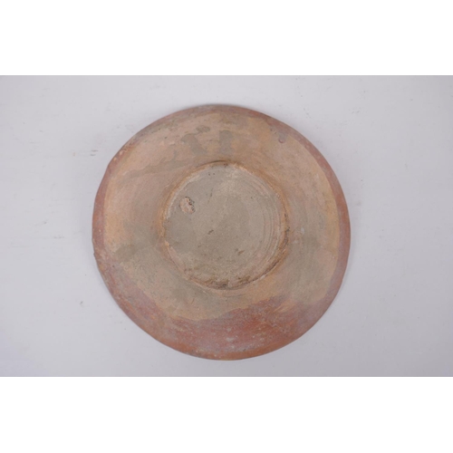 282 - An Islamic terracotta bowl decorated with a unique design, AF repairs, 23cm diameter