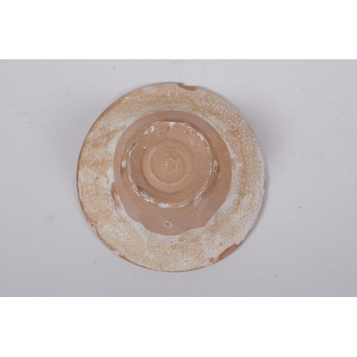 283 - A small middle eastern terracotta bowl with painted deer decoration, 11cm diameter