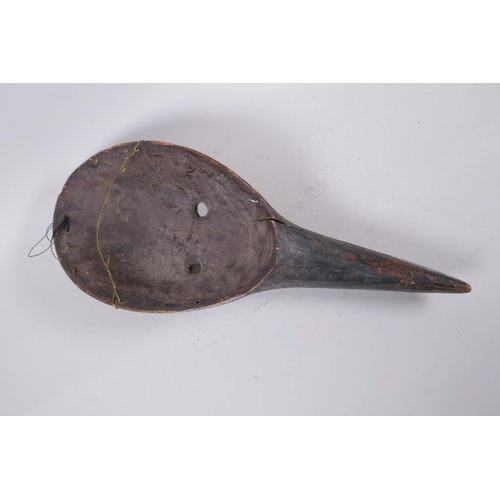 286 - An antique African painted wood mask, 46cm long