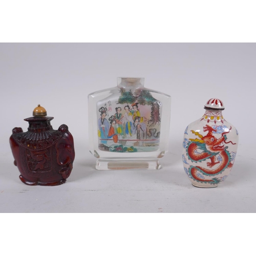 294 - A Chinese reverse decorated glass snuff bottle, a Canton enamel dragon snuff bottle, and a faux horn... 