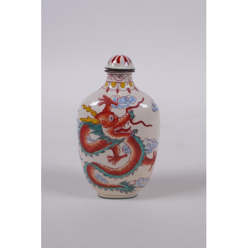 294 - A Chinese reverse decorated glass snuff bottle, a Canton enamel dragon snuff bottle, and a faux horn... 