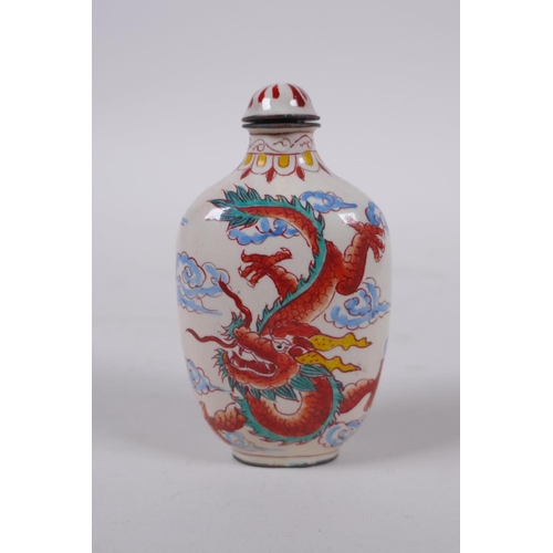 294 - A Chinese reverse decorated glass snuff bottle, a Canton enamel dragon snuff bottle, and a faux horn... 