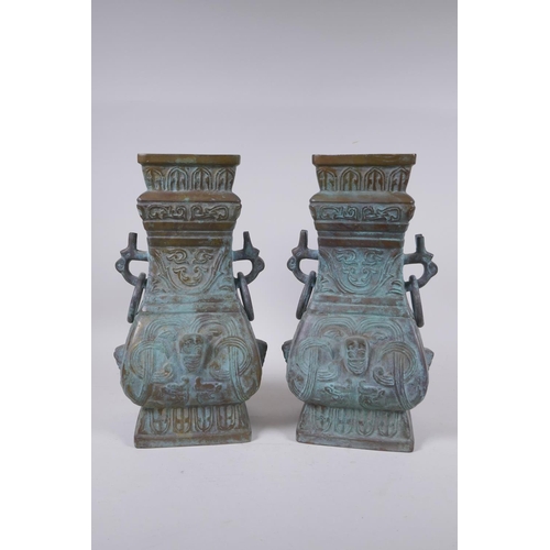 295 - A pair of Chinese archaic style bronze vases with two dragon loop handles, lack bases, 32 cm high