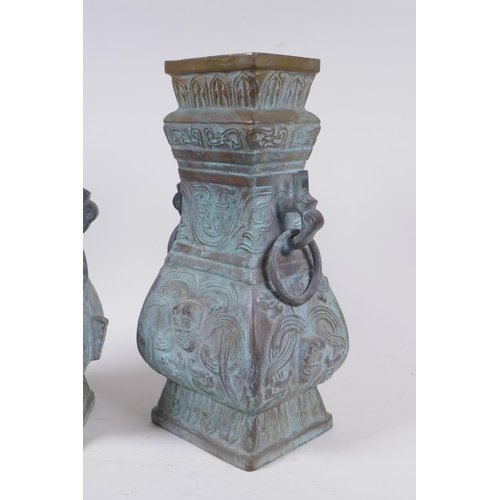 295 - A pair of Chinese archaic style bronze vases with two dragon loop handles, lack bases, 32 cm high