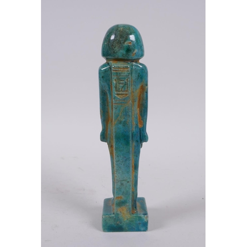 299 - An Egyptian faience turquoise glaze shabti, 21cm high