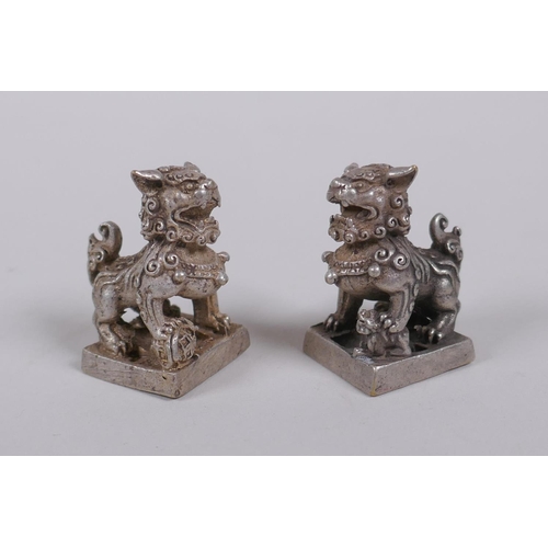 30 - A pair of Chinese white metal seals with Fo dog knops, 3cm high